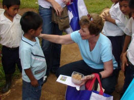 Sherry presenting a gift to a Guaymi boy